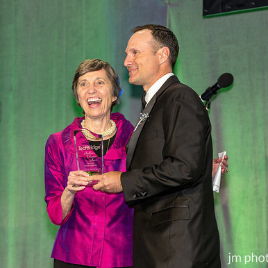 Ann Cramer of Coxe Curry & Associates presents the Ann Cramer Volunteer Award to Mark Farbman (SSI)