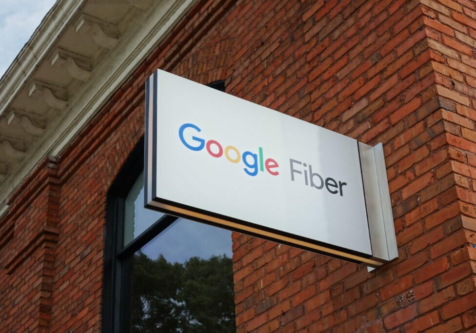 Google Fiber sign on red brick building.